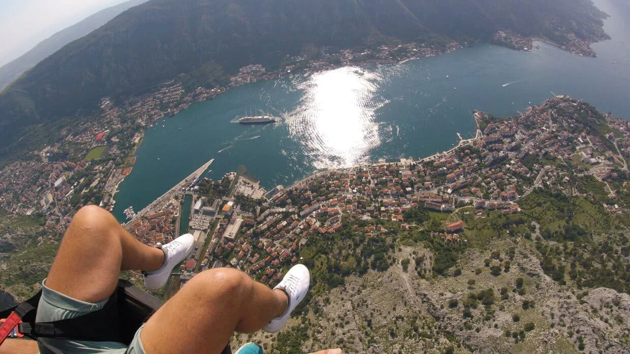 High tandem paragliding view above Kotor and the Bay.
