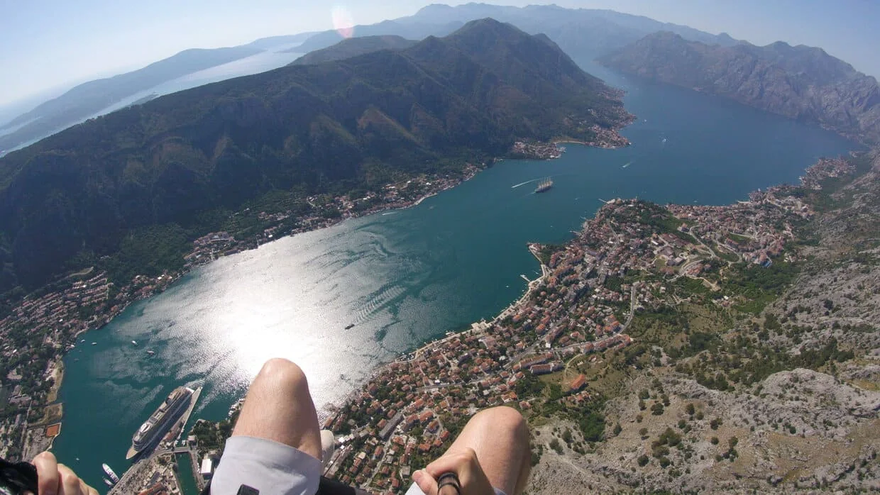 High paragliding route over the Bay of Kotor with mountain walls around the water.
