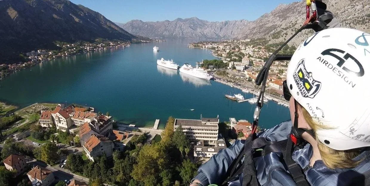 Bay of Kotor, mountain walls and Old Town context seen during paragliding.